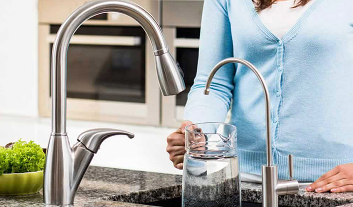 water flowing into glass cup
